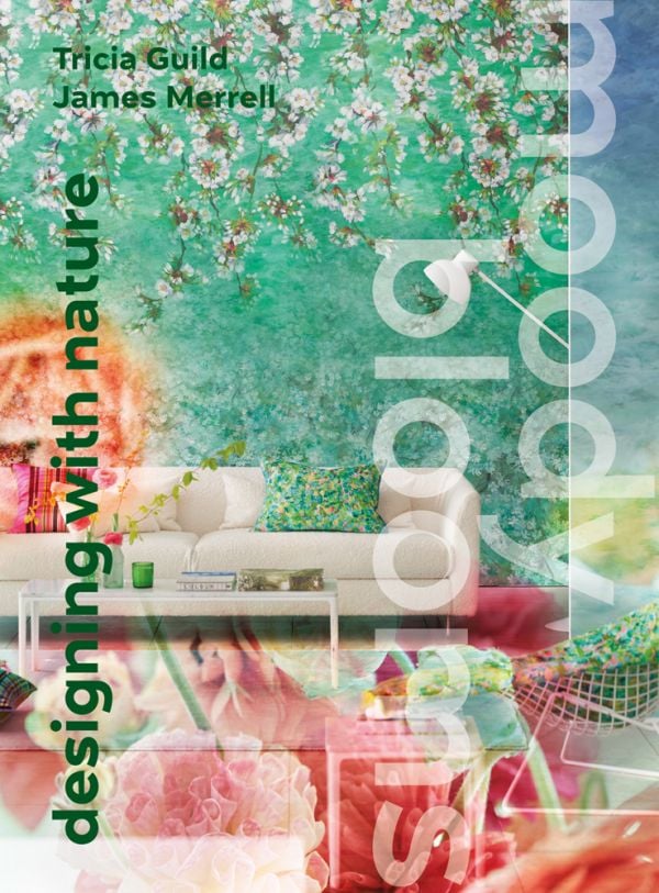 Book cover of Moody Blooms, with an interior space with blossom wallpaper, white sofa and coffee table. Published by ACC Art Books.