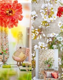 Colour image of a living space interior with a white sofa and coffee table with floral wallpaper and Tricia Guild Moody Blooms Designing with Nature in orange white and green and a transparent flower photograph layered on top