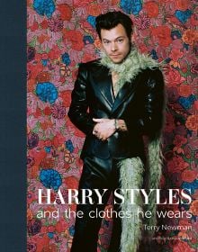 Book cover of Terry Newman's fashion guide, Harry Styles and the clothes he wears, with the singer posing in black leather look suit, beige fur boa, with floral backdrop. Published by ACC Art Books.