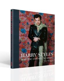 Book cover of Terry Newman's fashion guide, Harry Styles and the clothes he wears, with the singer posing in black leather look suit, beige fur boa, with floral backdrop. Published by ACC Art Books.