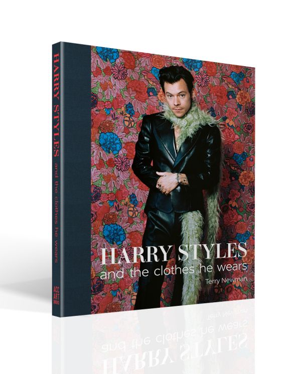 Book cover of Terry Newman's fashion guide, Harry Styles and the clothes he wears, with the singer posing in black leather look suit, beige fur boa, with floral backdrop. Published by ACC Art Books.