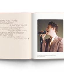 Book cover of Terry Newman's fashion guide, Harry Styles and the clothes he wears, with the singer posing in black leather look suit, beige fur boa, with floral backdrop. Published by ACC Art Books.