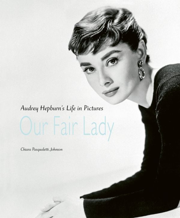 Book cover of Our Fair Lady: Audrey Hepburn’s Life in Pictures, featuring a portrait of actress Audrey Hepburn in a relaxed pose, by Bettmann. Published by ACC Art Books.