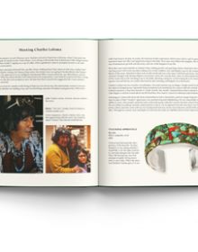 Large decorative gold bangle with tree design of green jewels, on green cover of 'EVELI A Jeweler’s Memoir', by ACC Art Books.