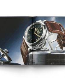 Two halves of a luxury silver wristwatch, on black cover of 'The Style of Time', by ACC Art Books.