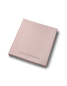 Pink silhouettes of jewelry pieces on darker pink cover of 'Cora Sheibani, Jewels', by ACC Art Books.