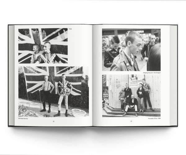 Book cover of Skins, featuring a young white male skinhead in black jacket, with his arms folded, looking to his left, and 'SKINS', in black graffiti on wall behind. Published ACC Art Books.