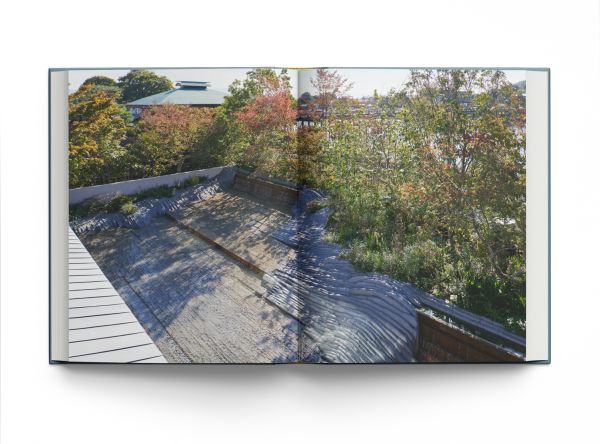 Book cover of Modern Japanese Gardens, with a Japanese garden with stones, pink blossom tree and small bridge. Published by ACC Art Books.