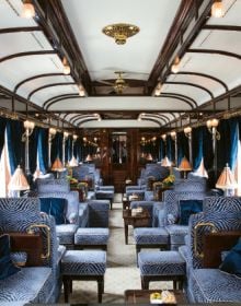 The luxurious Budapest Grand Suite on the Venice Simplon - Orient-Express, carved wood headboard, on cover of 'Luxury Trains', by ACC Art Books.