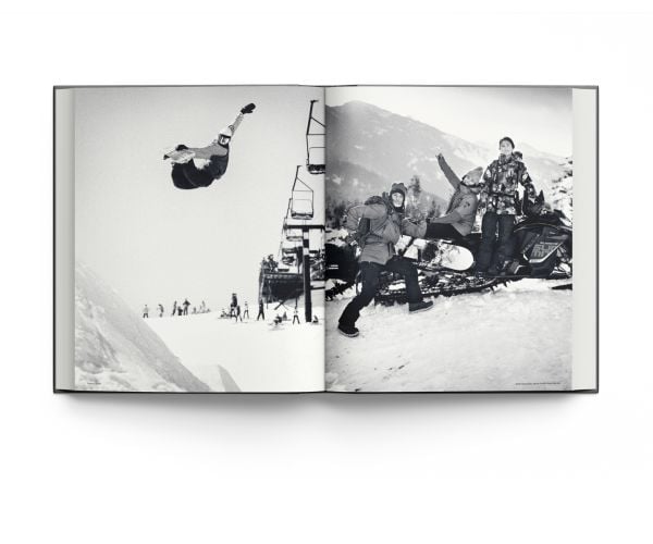 Book cover of Heroes, Women in Snowboarding, with female snowboarder sliding down rail of steps covered in snow. Published by ACC Art Books.