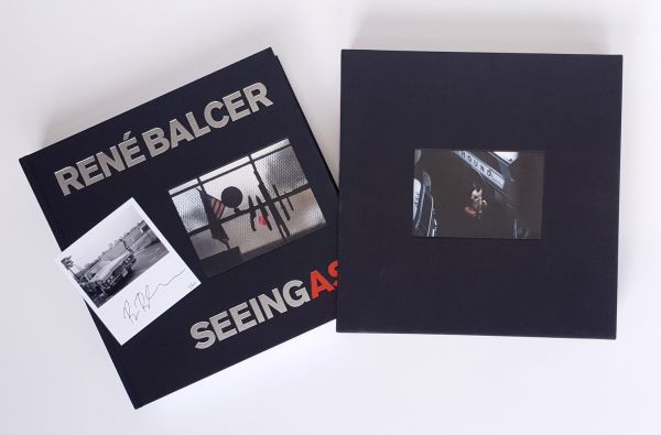 Book cover of Seeing As, René Balcer, with a row of knives and a machete, on a magnetic strip, with American flag and globe to left. Published by ACC Art Books.