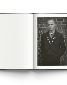 Portrait of white youth Tuinol Barry, Kings Road, 1983 by Derek Ridgers, on dark blue linen cover of 'The London Youth Portraits', by ACC Art Books.