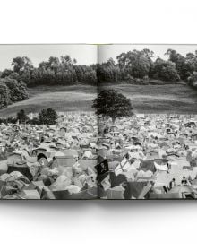 Book cover Liam Bailey's Glastonbury: The Festival and Its People, with festival goers standing at top of hill with tents behind them. Published by ACC Art Books.