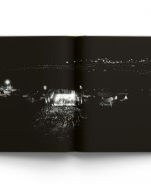 Book cover Liam Bailey's Glastonbury: The Festival and Its People, with festival goers standing at top of hill with tents behind them. Published by ACC Art Books.