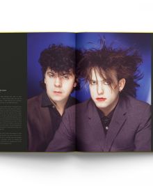 Book cover of The Cure: Stills, with a close up of front man Robert Smith in red lipstick. Published by ACC Art Books.