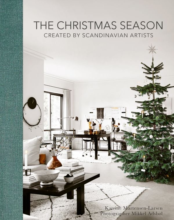 Book cover of The Christmas Season: Created by Scandinavian Artists; featuring an minimalist interior living room with a decorated Christmas tree. Published by ACC Art Books.