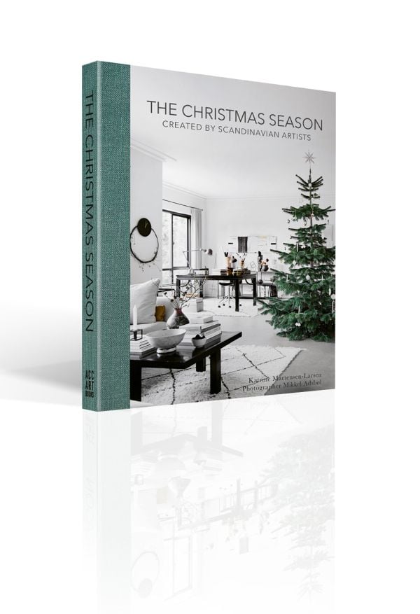 Book cover of The Christmas Season: Created by Scandinavian Artists; featuring an minimalist interior living room with a decorated Christmas tree. Published by ACC Art Books.