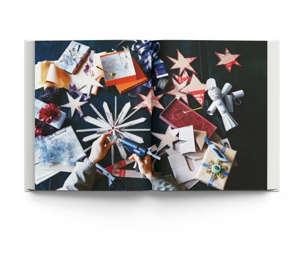 Book cover of The Christmas Season: Created by Scandinavian Artists; featuring an minimalist interior living room with a decorated Christmas tree. Published by ACC Art Books.