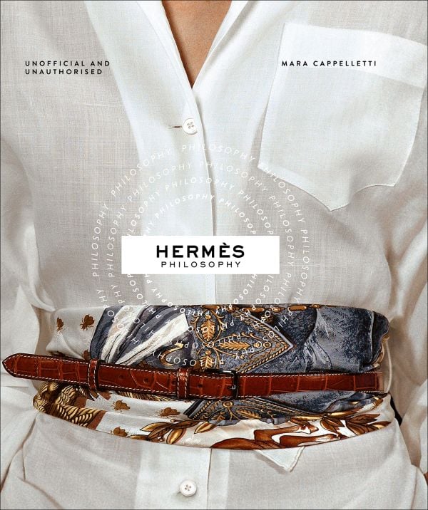 Book cover of Hermés Philosophy; featuring a model wearing a white linen shirt with a fabric and leather belt wrapped around waist. Published by ACC Art Books.