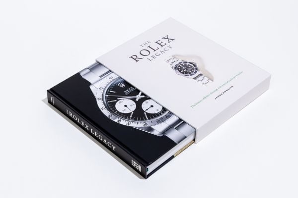 Book cover of The Rolex Legacy: The history of Rolex through 120 seminal and rare watches; featuring a silver Rolex watch. Published by ACC Art Books.