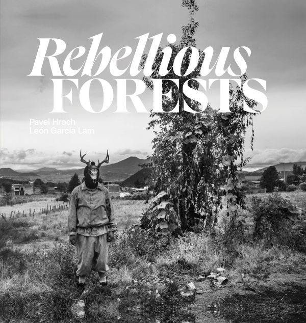 Book cover of Rebellious Forests, with a figure wearing a skeleton of animal on head, standing near a tree, with mountains behind. Published by Kulturalis.