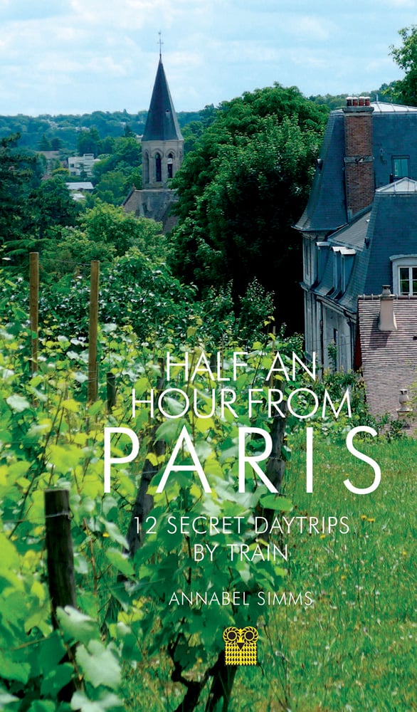 Vineyard with French commune behind, on travel guide cover of 'Half an Hour from Paris, 12 Secret Daytrips by Train', by Pallas Athene.