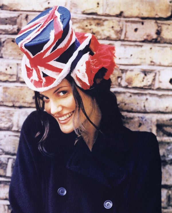 British milliner Stephen Jones wearing flamboyant, ruched hat to side of head, on cover of 'Stephen Jones, And the Accent of Fashion', by ACC Art Books.