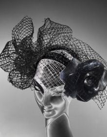 British milliner Stephen Jones wearing flamboyant, ruched hat to side of head, on cover of 'Stephen Jones, And the Accent of Fashion', by ACC Art Books.