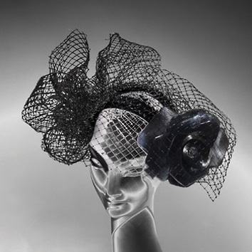 British milliner Stephen Jones wearing flamboyant, ruched hat to side of head, on cover of 'Stephen Jones, And the Accent of Fashion', by ACC Art Books.