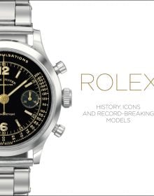 Silver Rolex oyster watch, with black face, on white cover of 'Rolex, History, Icons and Record-Breaking Models', by ACC Art Books.