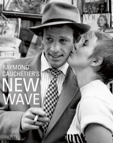 Book cover of Raymond Cauchetier's New Wave, featuring Jean Seberg kissing Jean Paul Belmondo's cheek on set from 1960 film 'Breathless'. Published by ACC Art Books.
