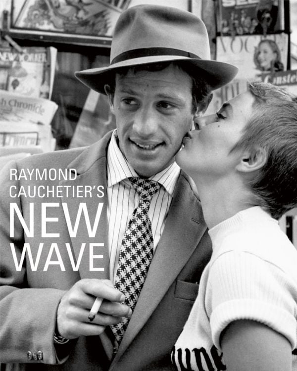 Book cover of Raymond Cauchetier's New Wave, featuring Jean Seberg kissing Jean Paul Belmondo's cheek on set from 1960 film 'Breathless'. Published by ACC Art Books.