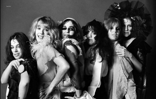 Book cover of Groupies and Other Electric Ladies, featuring two women; one with tongue near the others mouth. Published by ACC Art Books.