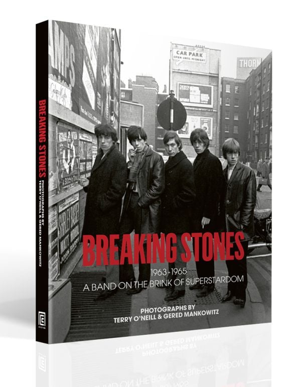 Book cover of Breaking Stones, featuring The Rolling Stones with Brian Jones, standing on city street. Published by ACC Art Books.