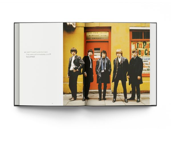 Book cover of Breaking Stones, featuring The Rolling Stones with Brian Jones, standing on city street. Published by ACC Art Books.