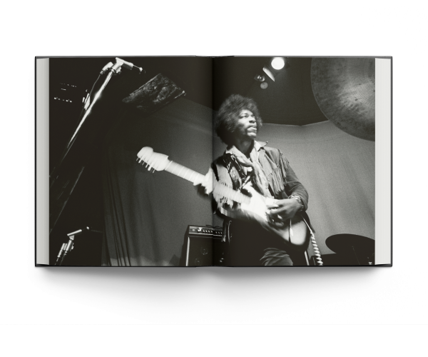 Book cover of Burning Desire: The Jimi Hendrix Experience Through the Lens of Ed Caraeff; featuring rock guitar legend Jimi Hendrix setting fire to his Fender Stratocaster. Published by ACC Art Books.
