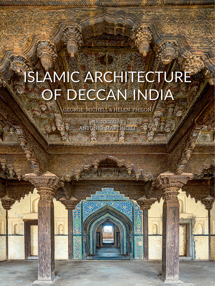Interior building with carved wood ceiling, blue tiles, Islamic Architecture of Deccan India in white font above.