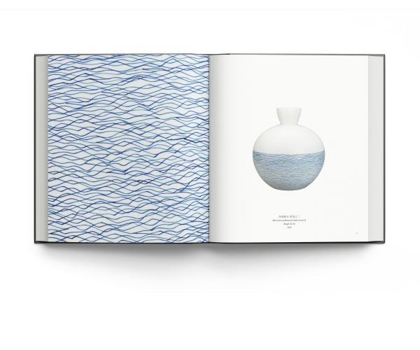 12 white shards of ceramic on black cover of 'Bai: The New Language of Porcelain in China', by ACC Art Books.