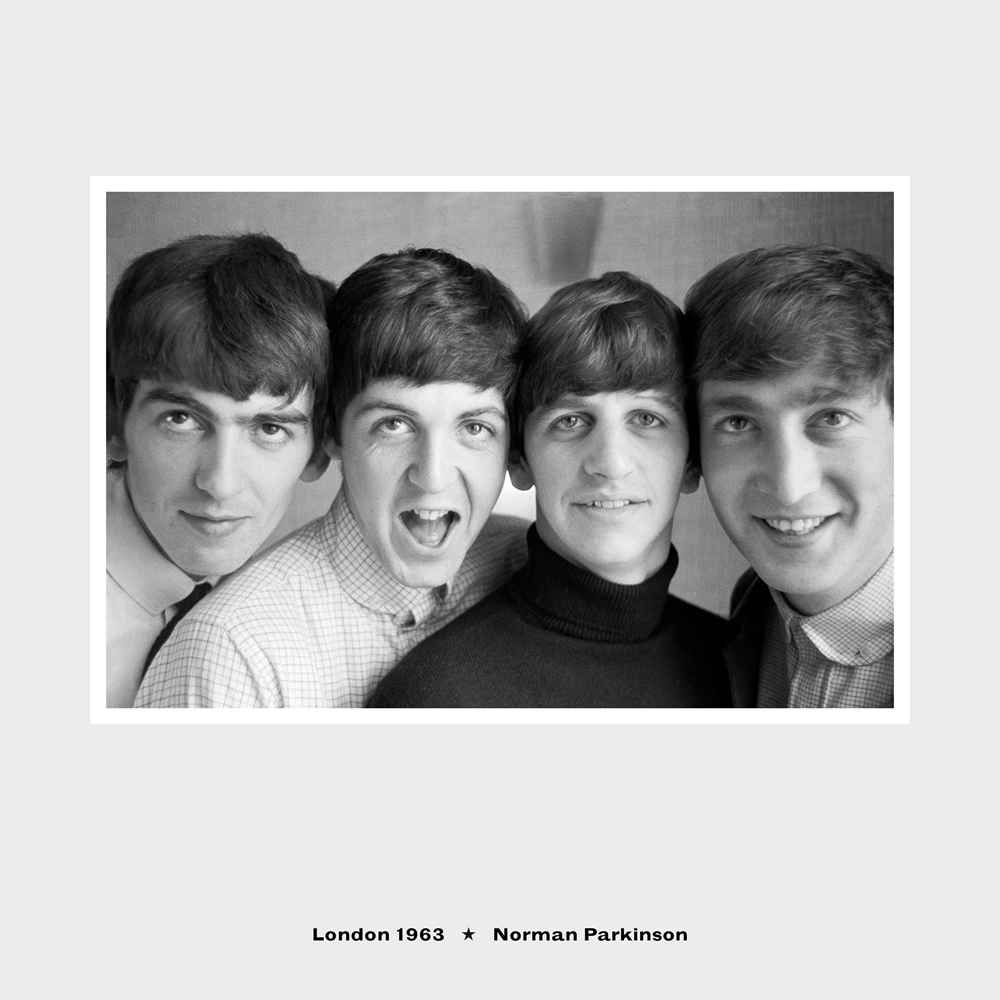 Landscape group shot of the four Beatles grinning at the camera with London, 1963 Norman Parkinson in small black text below