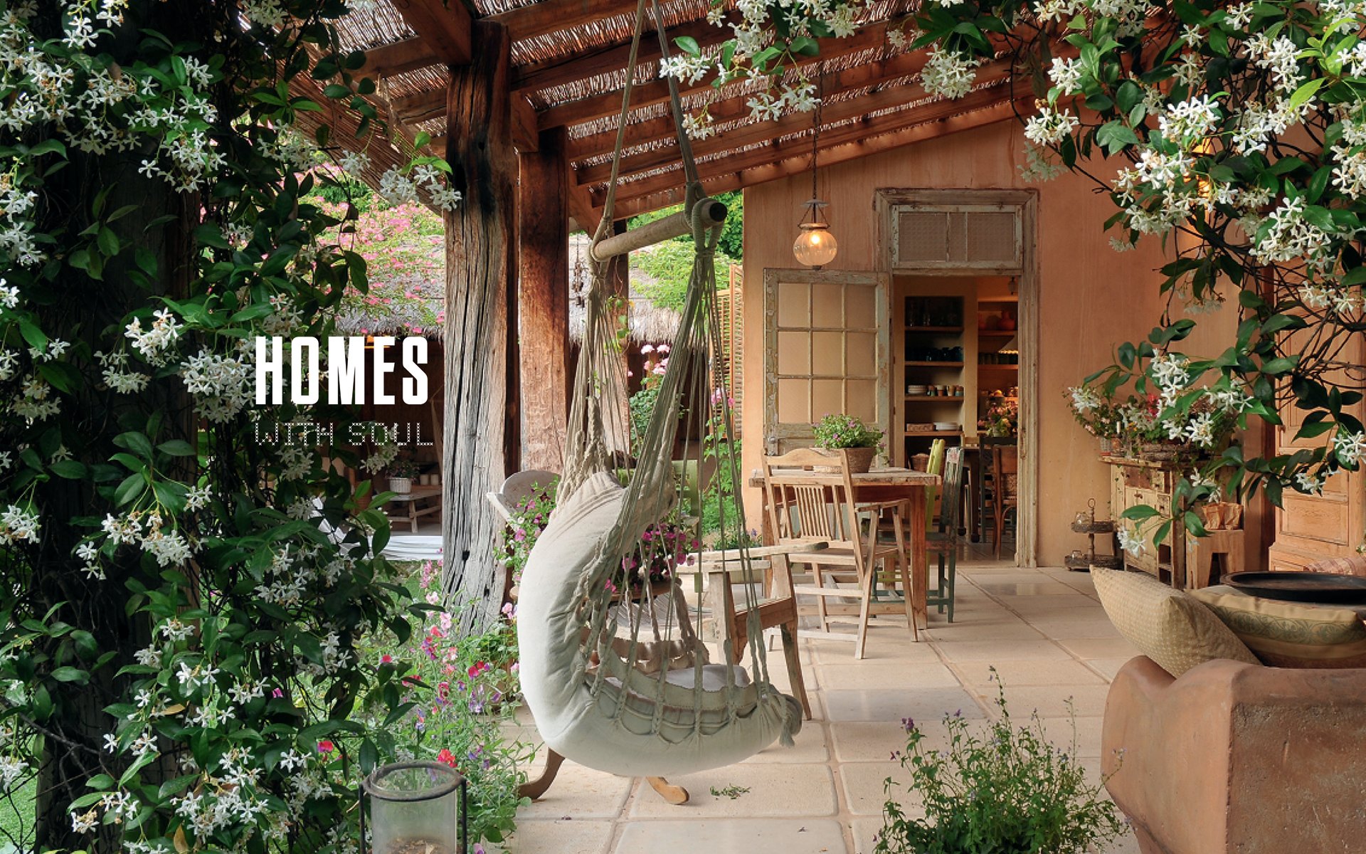 Wooden rocking chair on woven rug, cream walls and soft sofa, Homes With Soul in white font