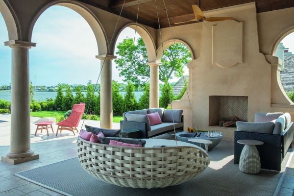 Book cover of On Interior Design featuring a beige interior space, with a sofa to center, an open fire and hanging light fittings from ceiling. Published by Images Publishing.