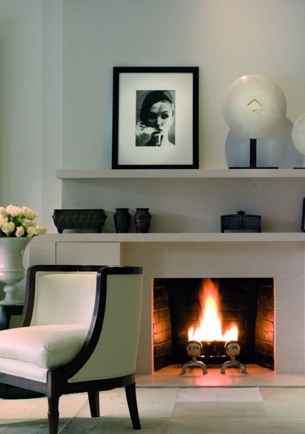 Book cover of On Interior Design featuring a beige interior space, with a sofa to center, an open fire and hanging light fittings from ceiling. Published by Images Publishing.