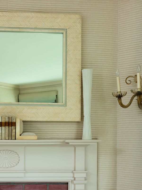 Book cover of On Interior Design featuring a beige interior space, with a sofa to center, an open fire and hanging light fittings from ceiling. Published by Images Publishing.