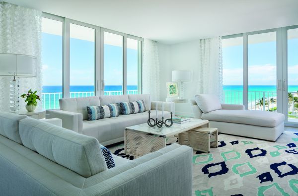 Book cover of On Interior Design featuring a beige interior space, with a sofa to center, an open fire and hanging light fittings from ceiling. Published by Images Publishing.