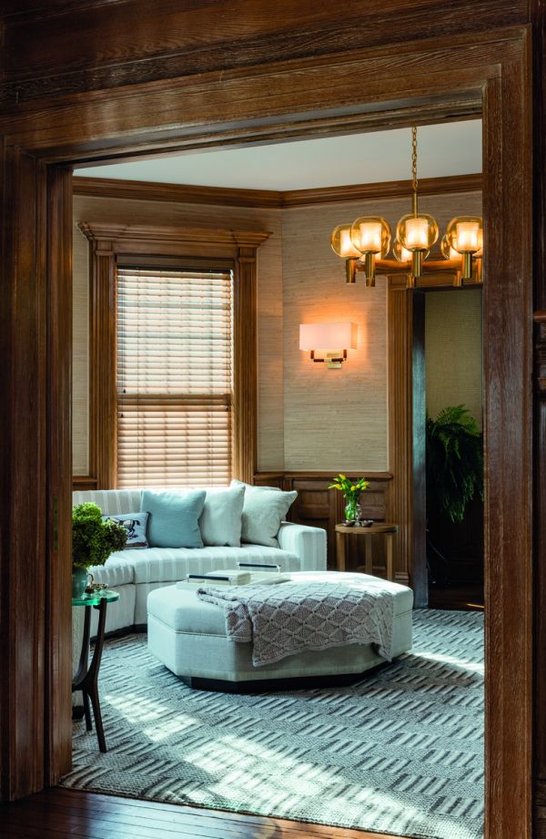 Book cover of On Interior Design featuring a beige interior space, with a sofa to center, an open fire and hanging light fittings from ceiling. Published by Images Publishing.