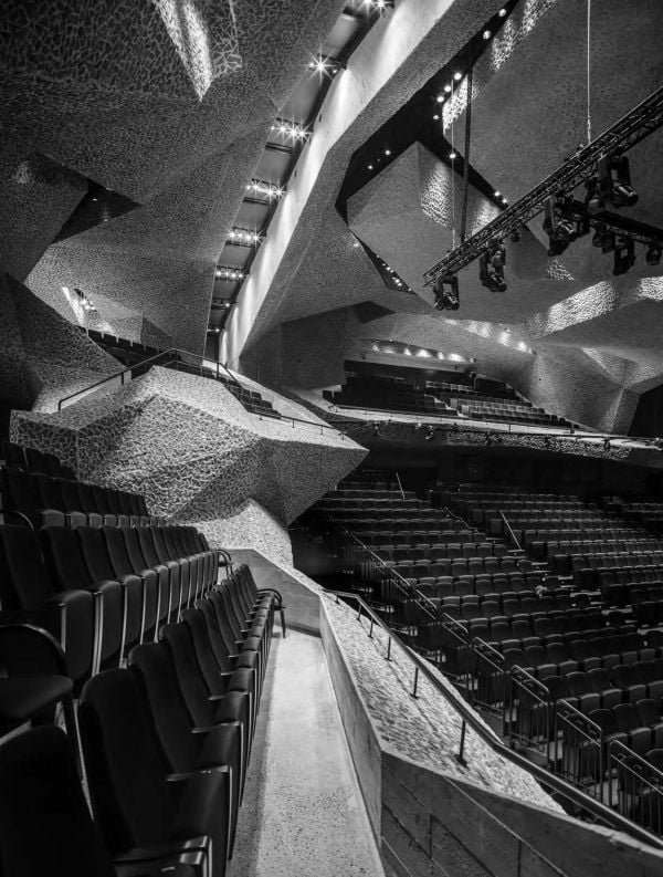 Latticed metal surface over brickwork, Brick Stone Metal Wood BUILDING ON TRADITION in white font to centre.