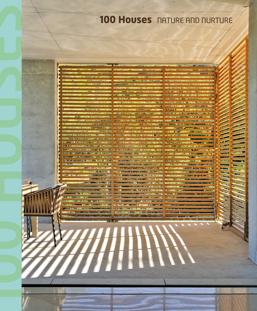 Interior space with wood slated panels revealing exterior landscape, 100 Houses NATURE AND NURTURE in brown font above.