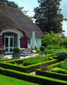Book cover of Private Gardens: Design Secrets to Creating Beautiful Outdoor Living Spaces, featuring a lush green landscape garden, paving stones leading to foliage covered arch. Publishing by Images Publishing.