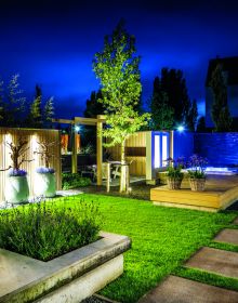 Book cover of Private Gardens: Design Secrets to Creating Beautiful Outdoor Living Spaces, featuring a lush green landscape garden, paving stones leading to foliage covered arch. Publishing by Images Publishing.