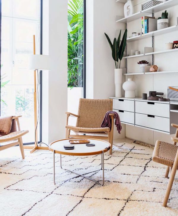 Book cover of Living Little: Simplicity and style in a small space, with an aerial view of figure lying on sofa. Published by Images Publishing.